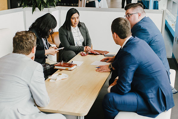People networking around a table